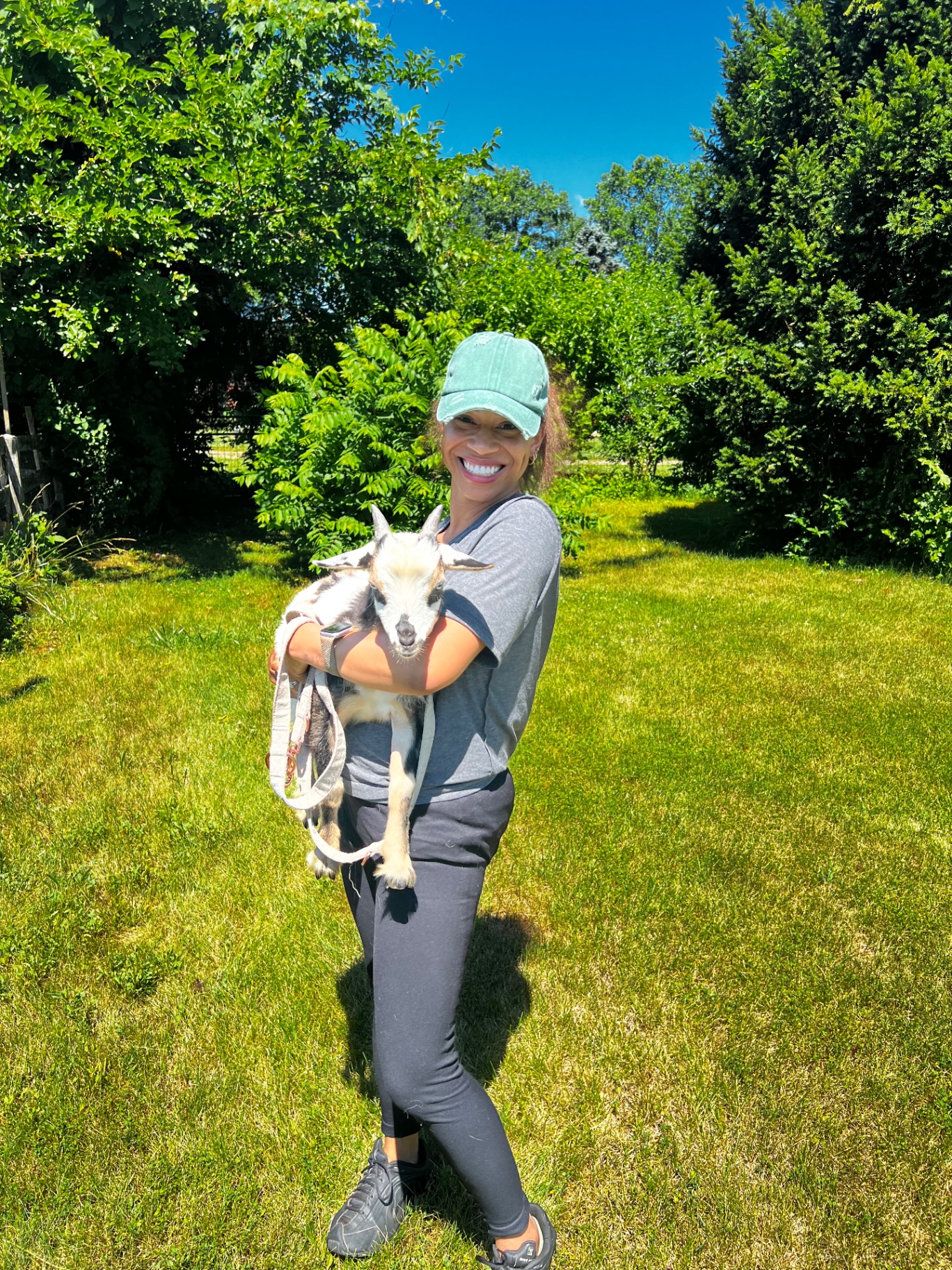 Victoria carrying one of the goats.